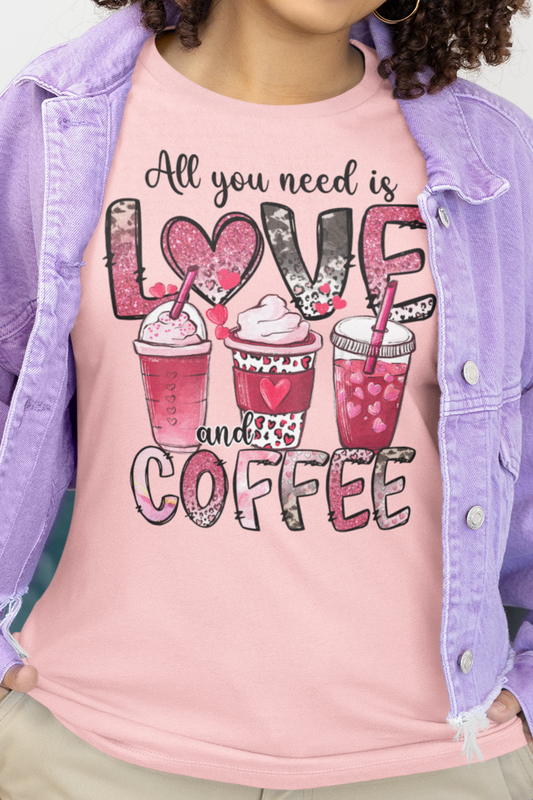 Pink Colored t-shirt with coffee graphic on front.  Three different style of coffees and the words "All You Need is Love and Coffee".  Back of shirt is plain , no graphic. Modeled by Woman