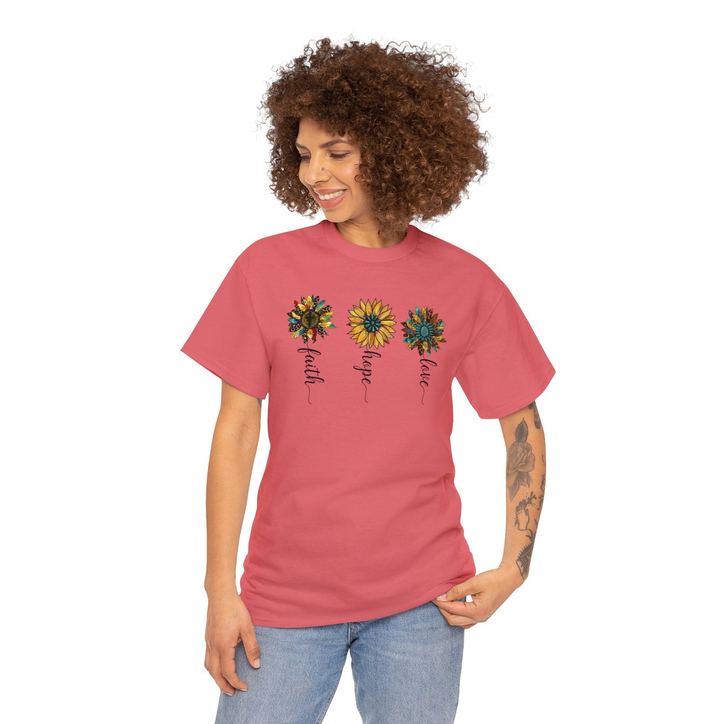 Coral Silk colored t-shirt with 3 different rustic vintage style sunflowers each with a different word as the stem.  Words are faith, hope and love. Graphic is on front of the shirt. Modeled by a woman.