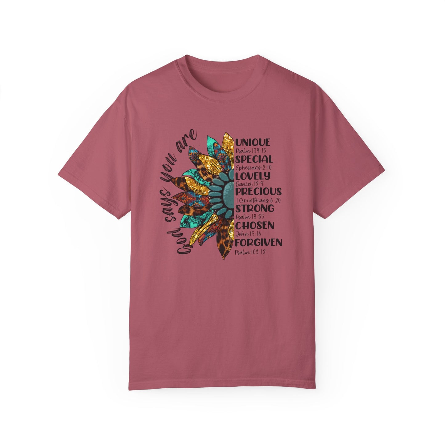 Crimson color t-shirt with half a sunflower with gold, teal and leopard print petals and a teal middle with the words "God says you are" arching it on the left of the flower and the words listed with referenced bible verses "unique, special, lovely, precious, strong, chosen and forgiven" filling the the opposite side of the flower