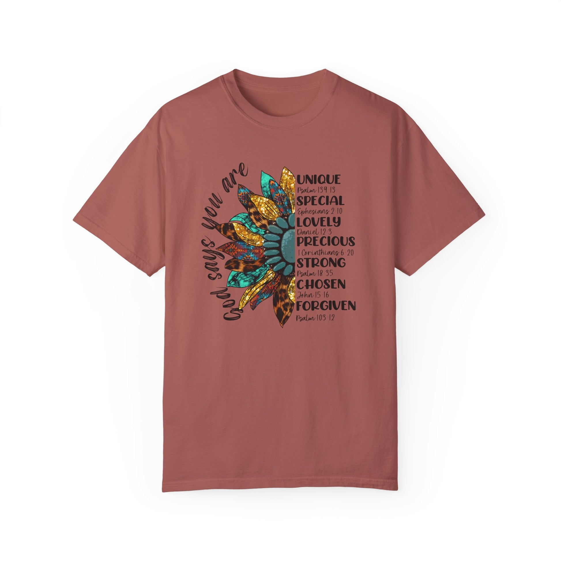 Cumin color t-shirt with half a sunflower with gold, teal and leopard print petals and a teal middle with the words "God says you are" arching it on the left of the flower and the words listed with referenced bible verses "unique, special, lovely, precious, strong, chosen and forgiven" filling the the opposite side of the flower