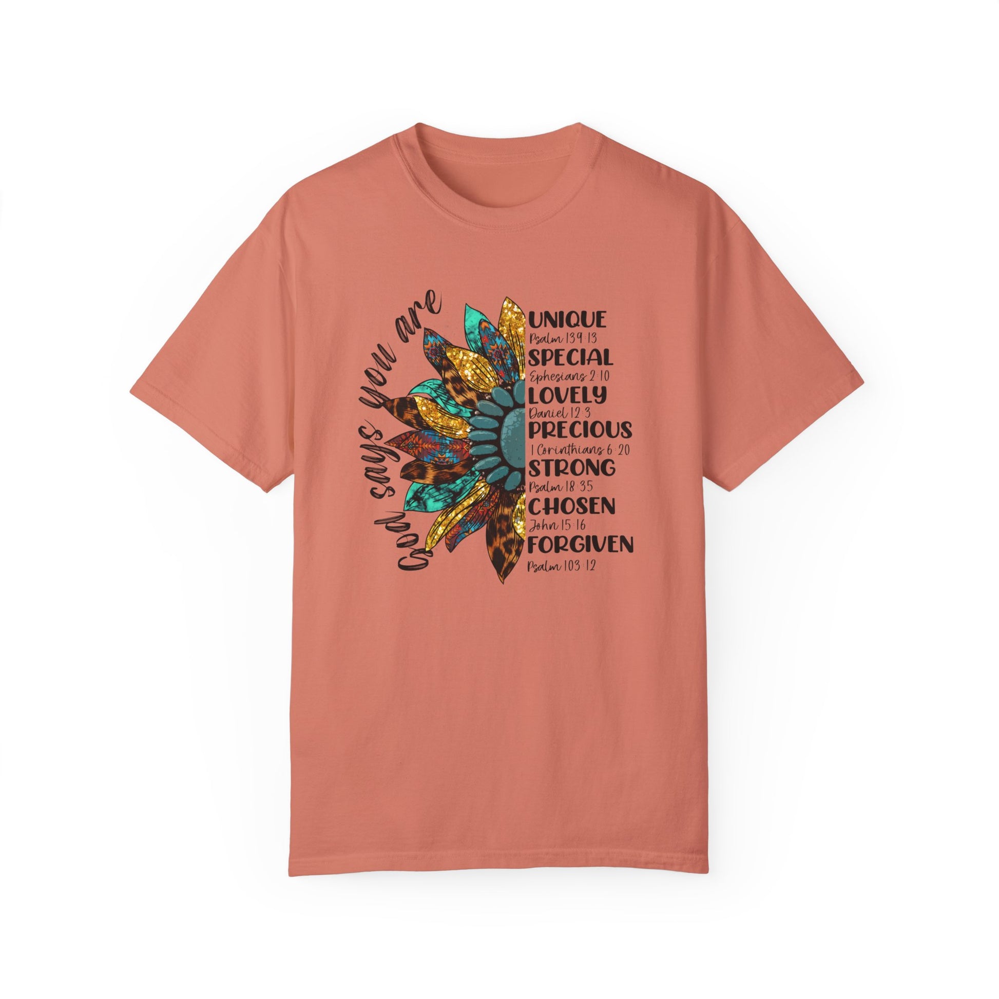 Terracotta color t-shirt with half a sunflower with gold, teal and leopard print petals and a teal middle with the words "God says you are" arching it on the left of the flower and the words listed with referenced bible verses "unique, special, lovely, precious, strong, chosen and forgiven" filling the the opposite side of the flower