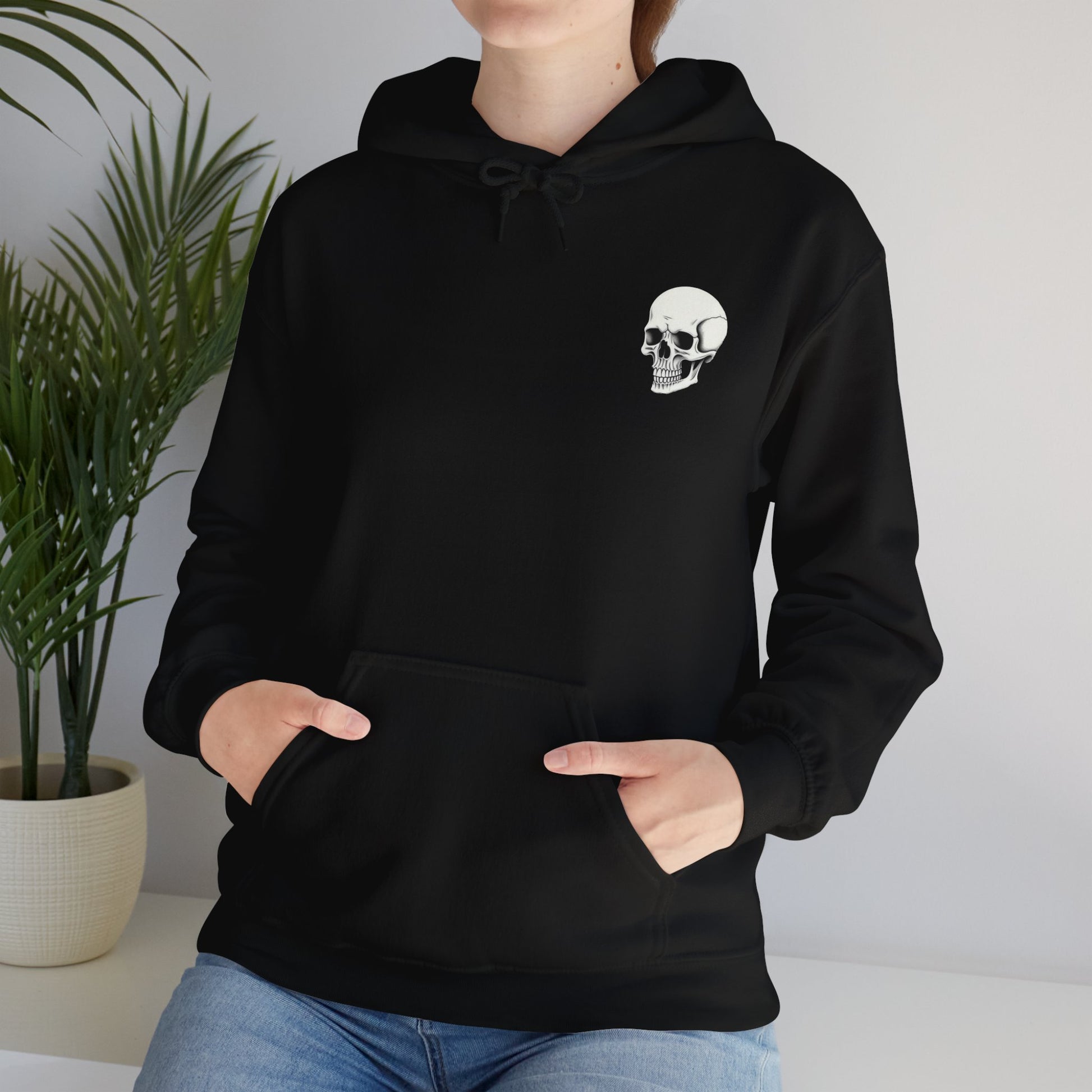 Black colored hoodie sweatshirt with graphic on front and back.  Front has a skeleton head on the left hand side picket area.  The back has a skeleton waist up drinking a cup of coffee that says "I Hate Everyone But Coffee Helps"  Female modeling the front of sweatshirt