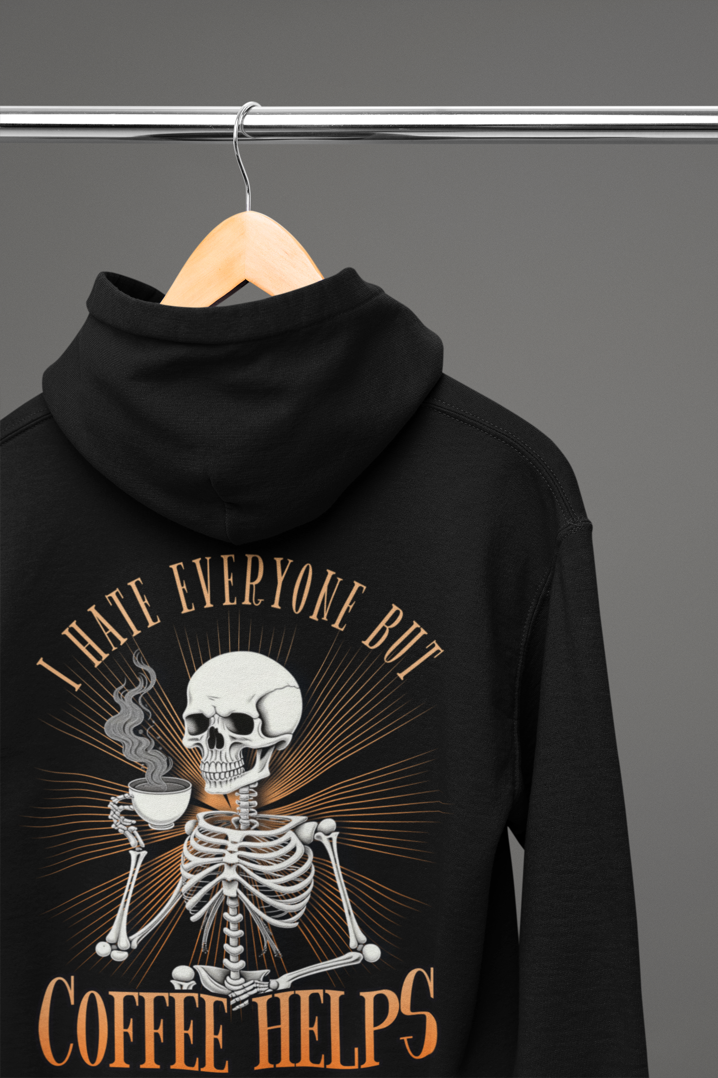 Black colored hoodie sweatshirt with graphic on front and back.  Front has a skeleton head on the left hand side picket area.  The back has a skeleton waist up drinking a cup of coffee that says "I Hate Everyone But Coffee Helps"  