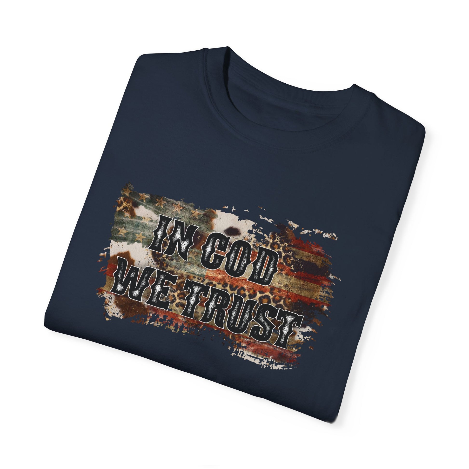 Navy colored folded t-shirt with a worn flag across chest and the words "In God We Trust" overlaid on top