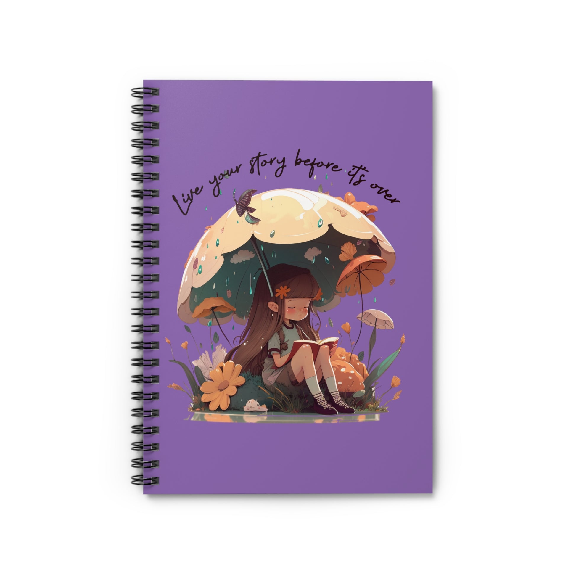 Spiral notebook with girl sitting under an umbrella reading a book in the rain surrounded by flowers and mushrooms with the words live your story before it's over arching above the umbrella