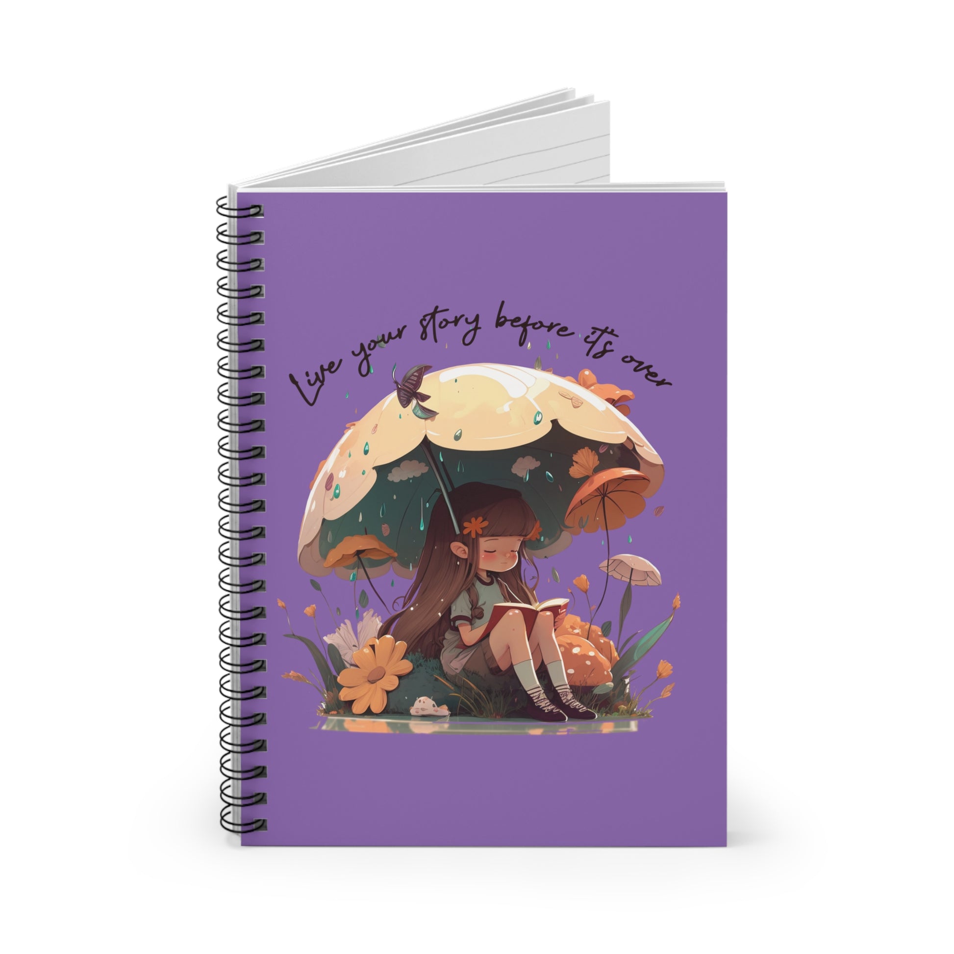 Spiral notebook with girl sitting under an umbrella reading a book in the rain surrounded by flowers and mushrooms with the words live your story before it's over arching above the umbrella