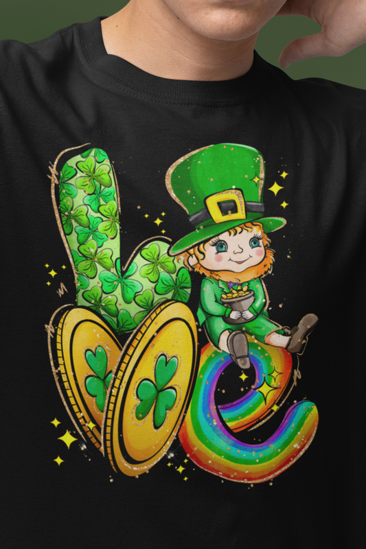 Black Color Shirt spelling out the word love with a leprechaun representing the letter "O", two gold coins for the letter "V", and a rainbow in the shape of a letter "E". mock up close up