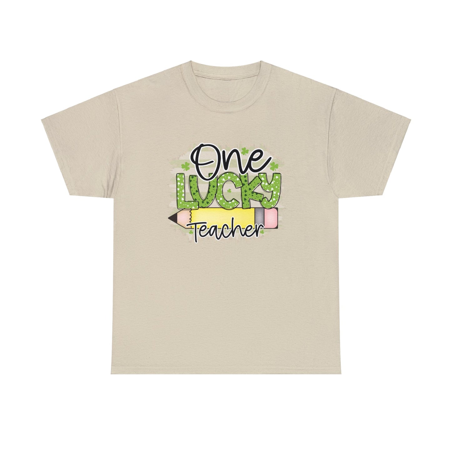 Sand color T-shirt with the words One in black Lucky in Green with White and Green Shamrocks and Teacher in Black with white outline.  There is a pencil graphic between the words lucky and teacher.