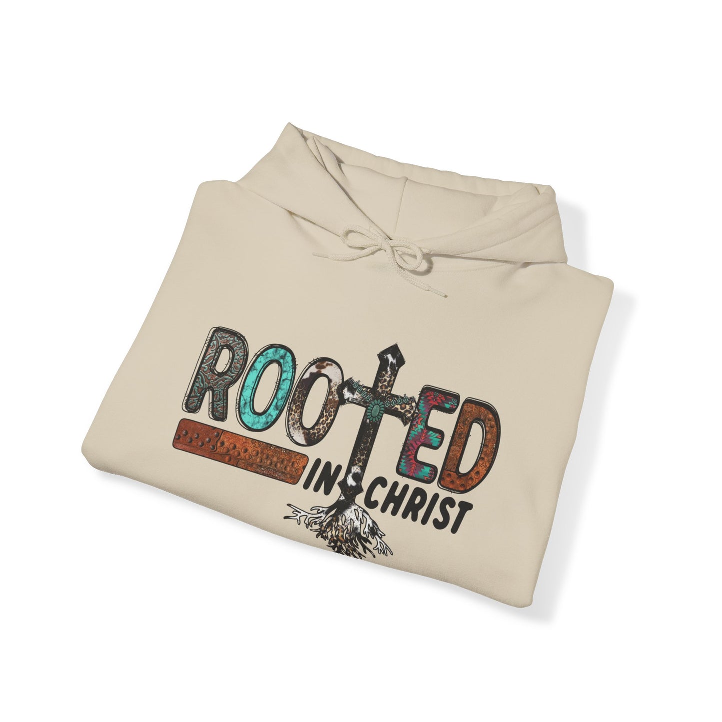 Folded Sand colored hoodie sweatshirt with the words Rooted in Christ across the chest with roots growing out of the T in the word rooted represented by a cross