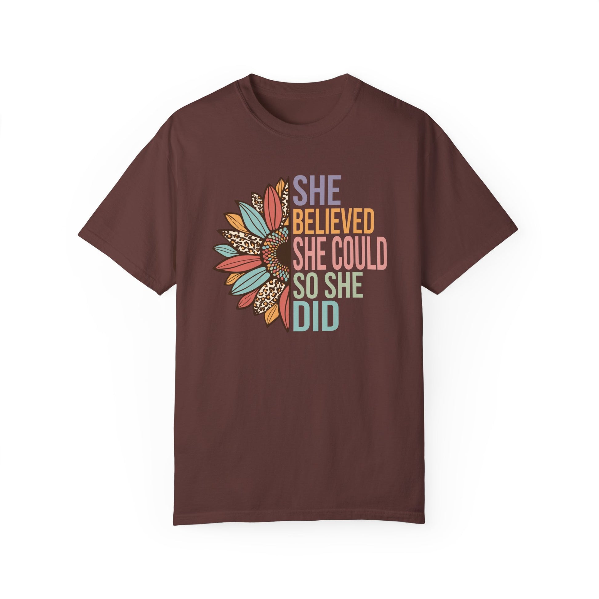 Vineyard colored t-shirt with the saying "She Believed She Could So She Did" as half of the sunflower and a retro design other half of the flower with petals of leopard print, teal, rust and golden yellow