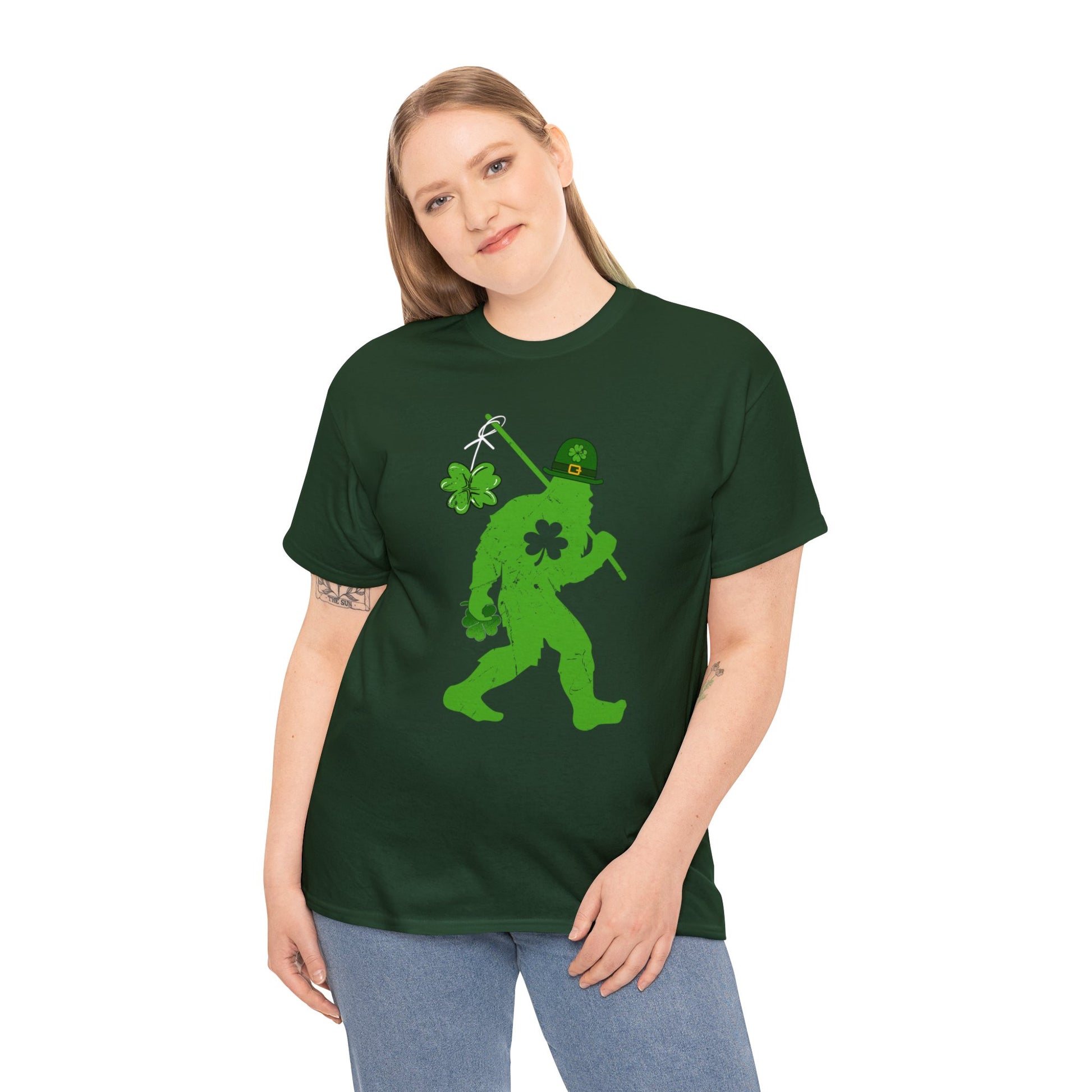 Forest Green color St. Patrick's Day T-shirt with bigfoot wearing a leprechaun hat carrying a fishing pole with a shamrock attached to it. Woman Mock up