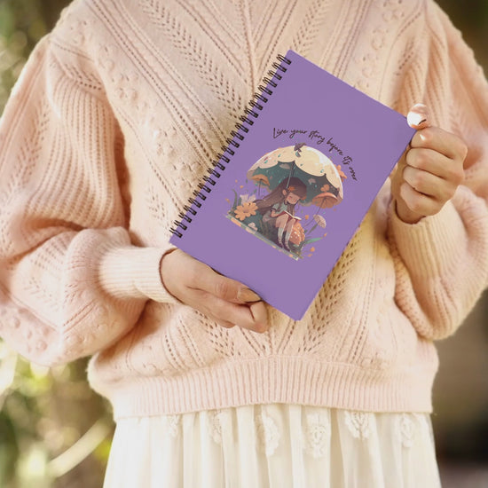 Video of woman holding notebook showing different angles of the front cover