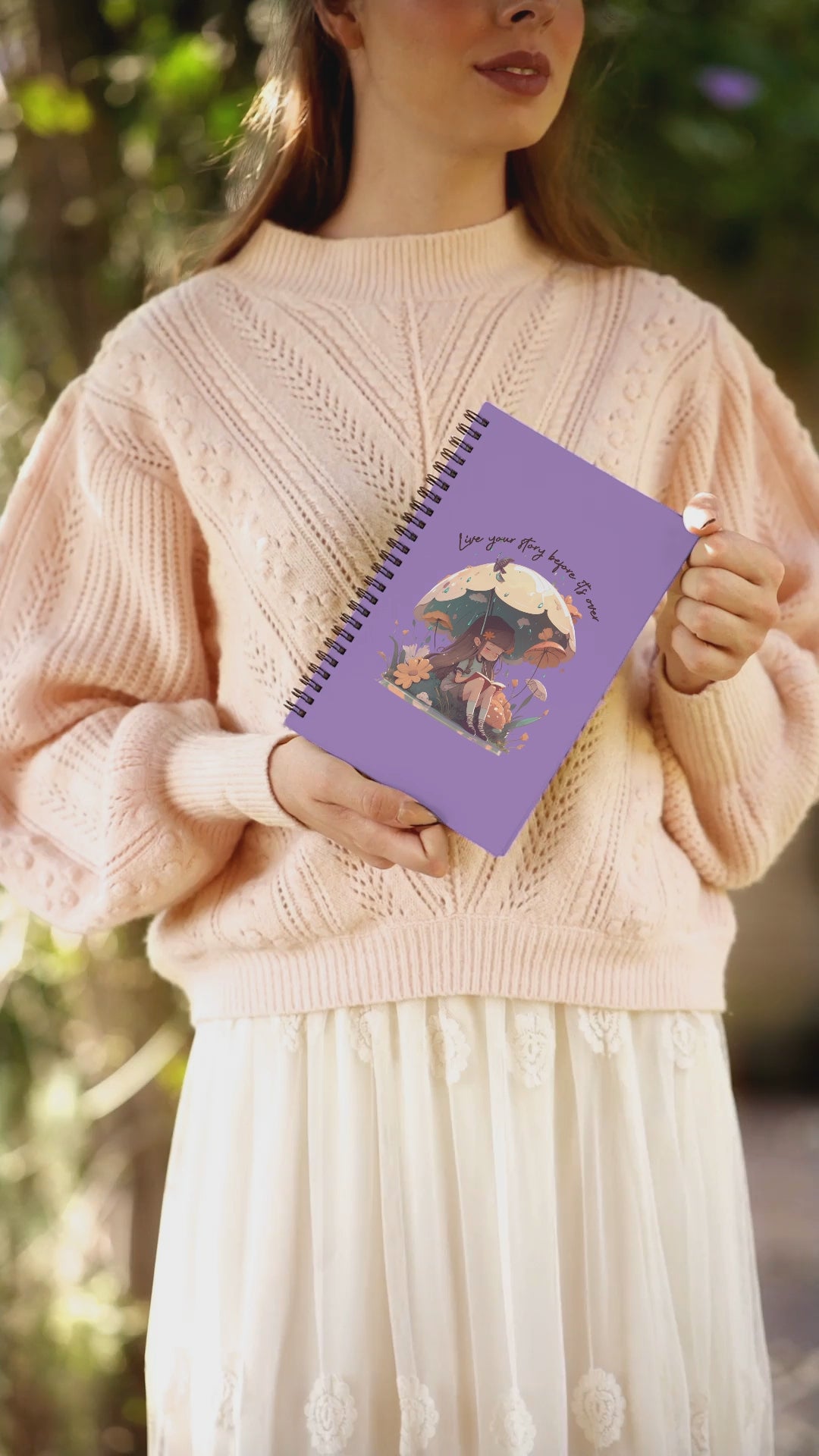 Video of woman holding notebook showing different angles of the front cover